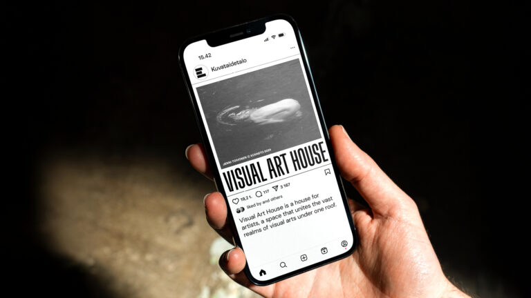 A picture of a phone with visual art house logo